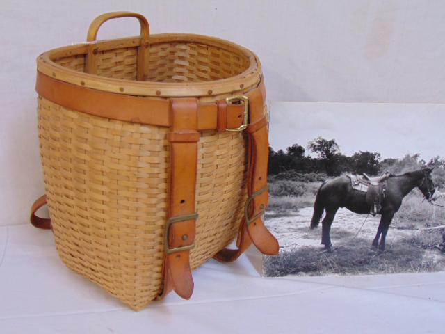 Stephen Zeh pack basket made for Guy Gillette, woven: Stephen Zeh pack basket made for Guy Gillette, woven pack basket with leather straps, 12.75" by 10.25", height is 15.5", basket in excellent condition, signed, comes with photograph by Guy Gillette.