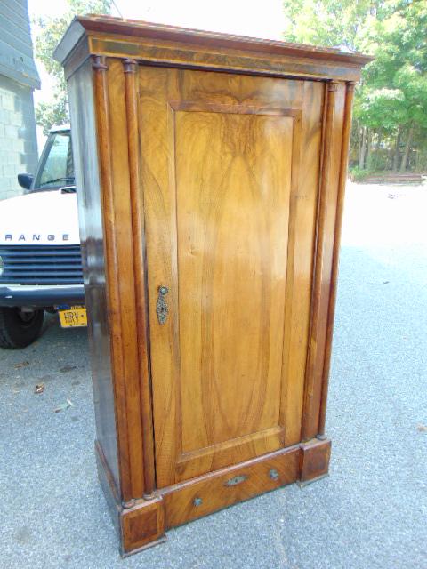 Biedermeier single door cabinet, drawer in base, with: Biedermeier single door cabinet, drawer in base, with double column sides, 19th Century, cabinet it 39.25" by 18.75", height is 68", some loss of veneer.