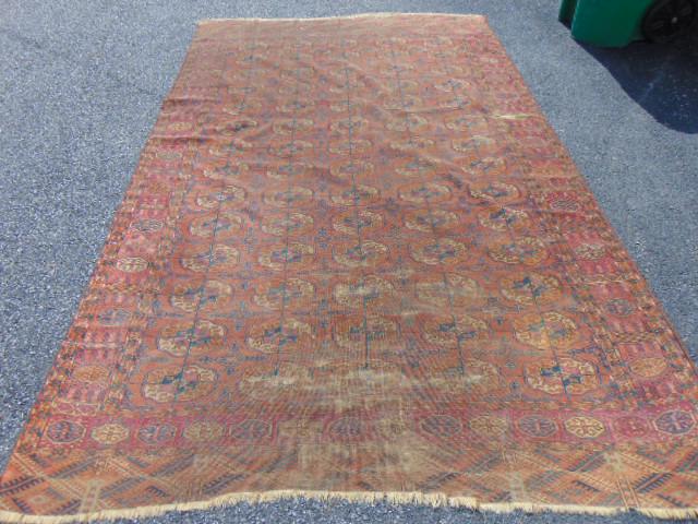 Early Bokhara carpet, rust red, carpet is 10'2" by: Early Bokhara carpet, rust red, carpet is 10'2" by 6'10", worn, several tears, some loss