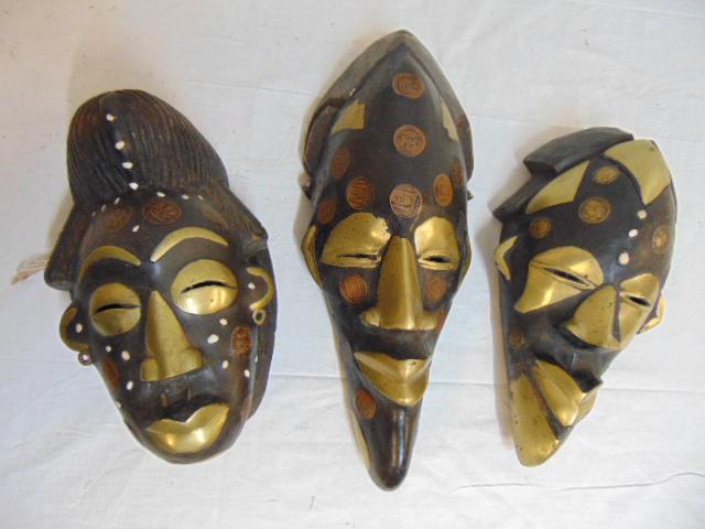 3 Nigerian tribal masks, decorated with brass & inlaid: 3 Nigerian tribal masks, decorated with brass & inlaid with Nigerian & French coins, African art, 10.25" to 15.5". br> Note this lot came from the collection of a noted American AP journalist
