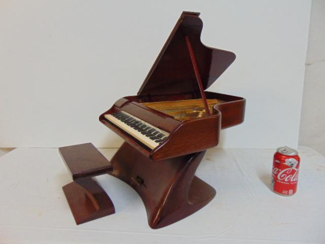 Model grand piano, Ed Klein, mid Century styled grand: Model grand piano, Ed Klein, mid Century styled grand piano model, with bench, hinge on lid is loose, some small repairs, model is 13.75" wide, 16.5" deep, height is 9.75".