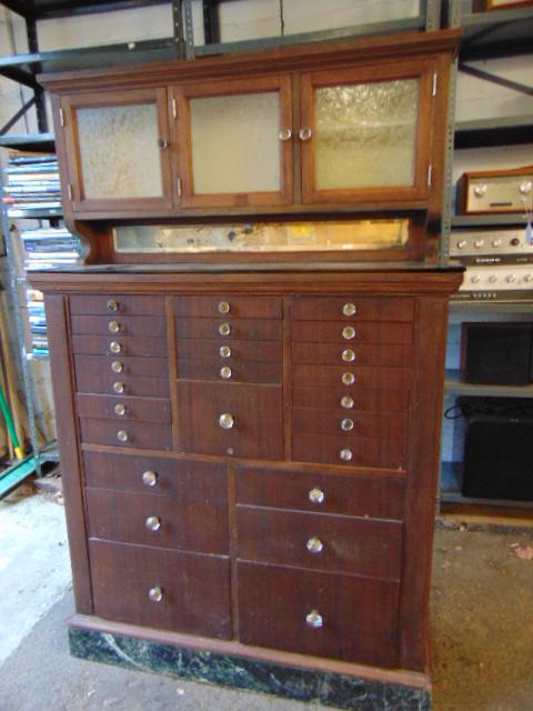 Dental cabinet, black glass top with upper cabinet,: Dental cabinet, black glass top with upper cabinet, marble base (one section broken),missing back cabinet is 40" by 12", height is 62.5"