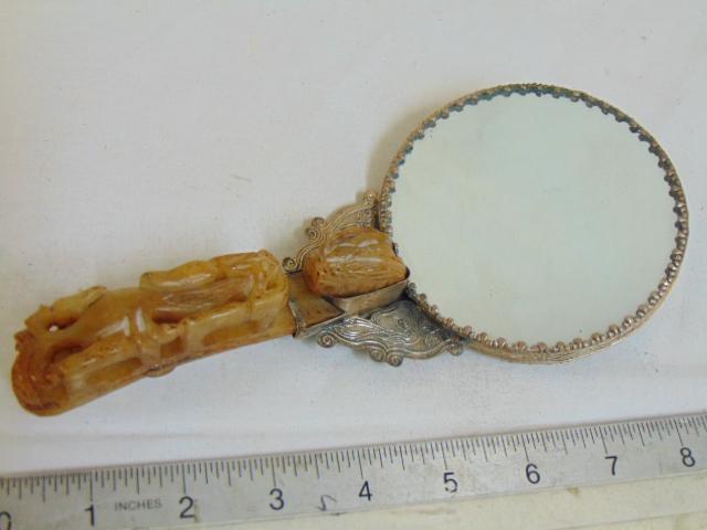 Chinese carved stone belt buckle, converted to mirror,: Chinese carved stone belt buckle, converted to mirror, Jade handle with applied decorative silver plate backed mirror