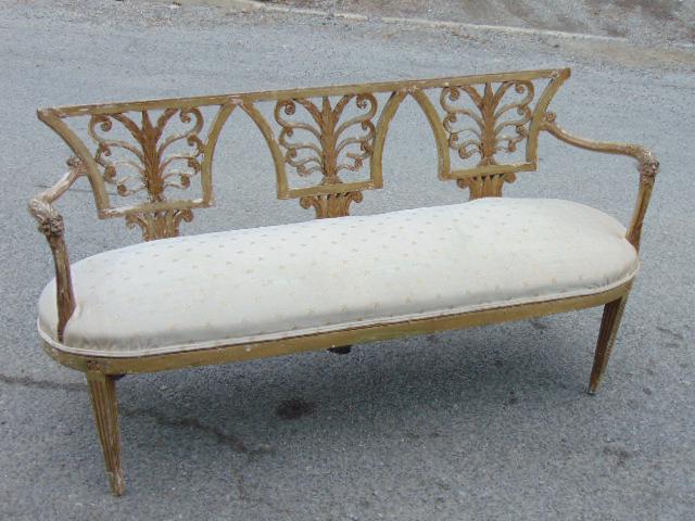 Antique carved French settee, upholstered seat, carved: Antique carved French settee, upholstered seat, carved back & carved lion heads on arm support, old paint, rear left leg has small part missing, settee is 66" by 21", height is 32.25"