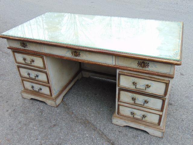 Decorative kneehole desk, paint decorated, faux partner: Decorative kneehole desk, paint decorated, faux partner desk, in white with blue decorations, glass top, desk is 61" by 31", height is 30.5"