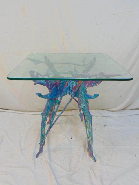 Paint decorated Memphis style iron base, glass top: Paint decorated Memphis style iron base, glass top table, various colors on base, top is 27.75" by 27.75", height is 28.25", glass top is chipped.