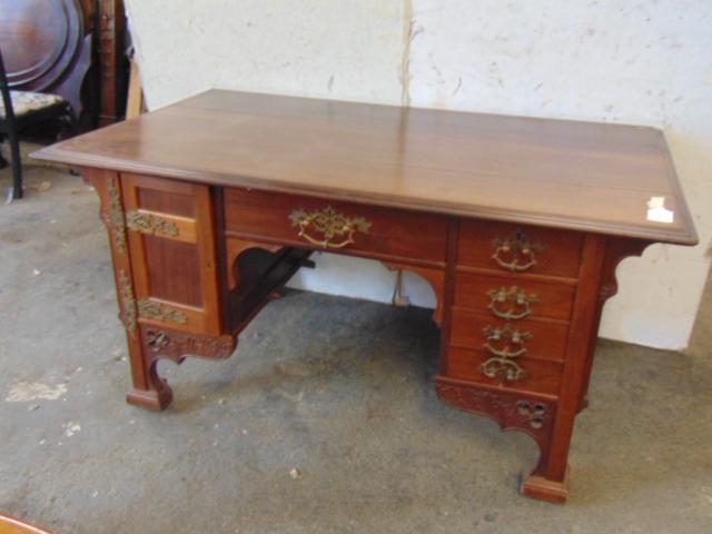 Early 20th Century partners desk, mahogany, arts &: Early 20th Century partners desk, mahogany, arts & crafts elements, top has partial split, carved detail & decorative brass hardware, top is 60" by 36", height is 30.5", one small decorative corner mi