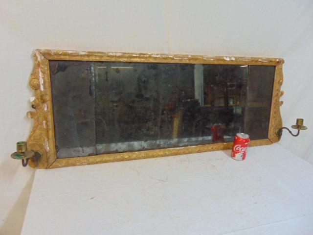 Early mirror with brass candle holder sconces, over: Early mirror with brass candle holder sconces, over mantle, gilt, loss of gilt, chips, frame is loose, glass in 3 sections, sold as found, 50" by 18"