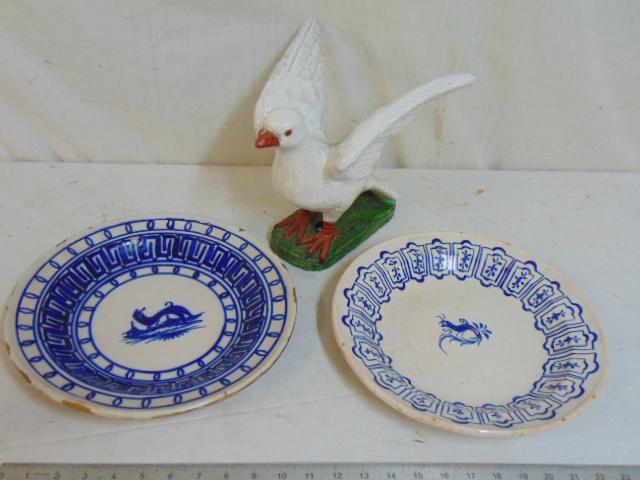 Terra cotta dove & two tin glazed plates, blue & white: Terra cotta dove & two tin glazed plates, blue & white paint decorated plates, 12" in diameter & glazed terra cotta dove stretching wings, one plate has small hairline.