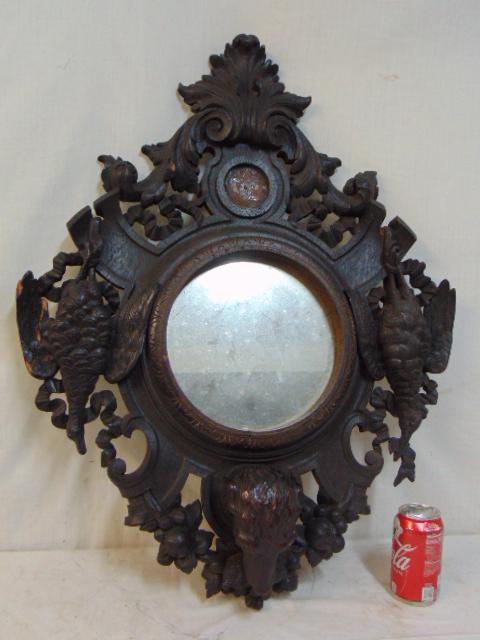 Black Forest carved mirror, with carved game, birds,: Black Forest carved mirror, with carved game, birds, dog head, & round mirror in center, some old repairs, mirror is 32.5" by 25".