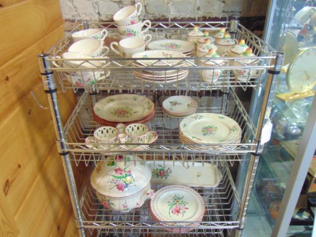 Lot Luneville floral decorated dinnerware, partial set,: Lot Luneville floral decorated dinnerware, partial set, includes tureen, 4 dinner plates, 5 bread plates, 10 cups & saucers, 8 "pot de Creme" pots with lids, 7 bread plates with reticulated edge, 4 sm