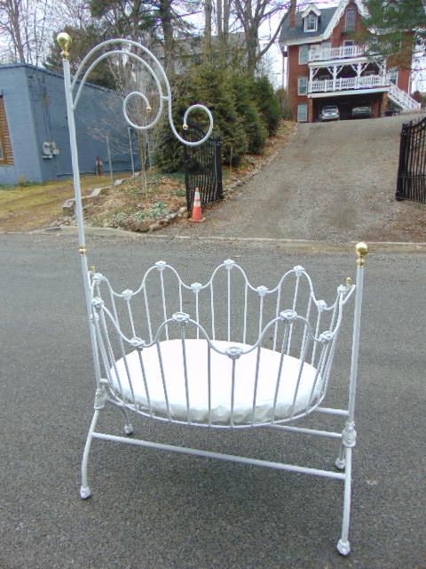 2 iron rocking bassinets cradles on stand, white: 2 iron rocking bassinets cradles on stand, white paint, with brass finials, balls, crib is 41.5" wide, 32.25" deep, height is 76".One crib has loose post, see last image.