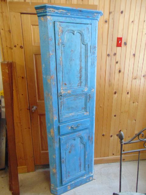 Tall corner cupboard in blue paint, 81.5" tall, has: Tall corner cupboard in blue paint, 81.5" tall, has door in upper & lower section, divided by drawer. Not antique