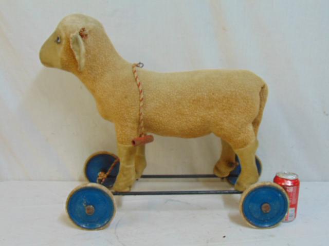 Steiff plush lamb pull toy, missing glass eyes, fair: Steiff plush lamb pull toy, missing glass eyes, fair condition, fur worn, ears loose, need mending, base is 11" by 22", height is 20.75"