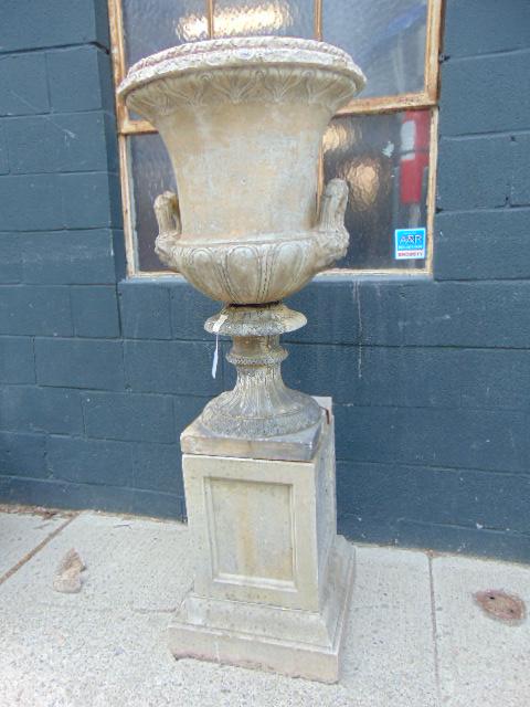 Cast limestone urn on pedestal, some loose pieces,: Cast limestone urn on pedestal, some loose pieces, repairs, urn is 57.5" tall, sold as is.