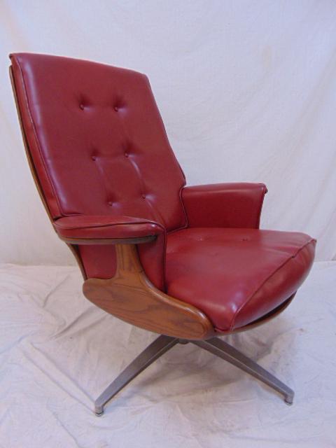 Mid Century swivel, rocking chair, red vinyl, in oak.: Mid Century swivel, rocking chair, red vinyl, in oak.