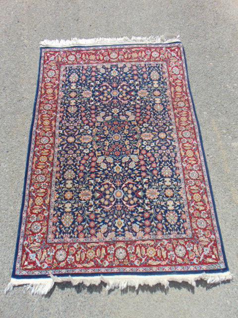 Scatter rug, in blue & red, marked "Hereke", carpet is (1 of 4)