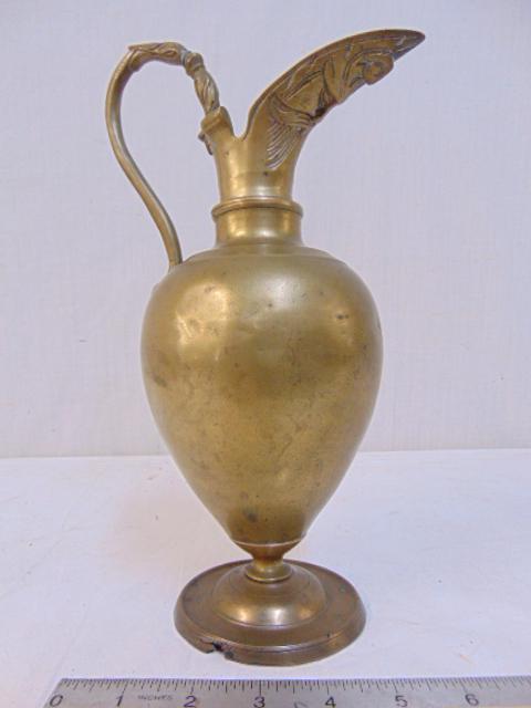 Brass claret , 17th / 18th Century, with decorative: Brass claret , 17th / 18th Century, with decorative handle, face of bearded man on body below handle, height is 11.75", some damage, loss at bottom edge.