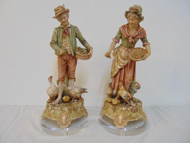 Pair of Royal Dux ceramic figures, boy feeding geese &: Pair of Royal Dux ceramic figures, boy feeding geese & woman feeding chicken, on Lucite bases, chicken repaired, height is 16"