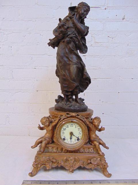 Spelter figural clock, ornately decorated with putti, (1 of 5)