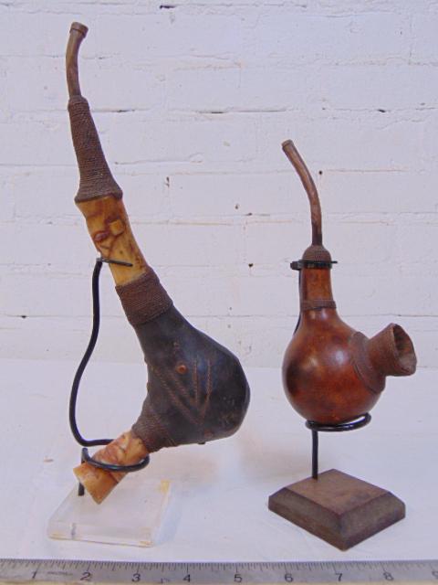 2 African tribal pipes, with carved detail, woven bowl,: 2 African tribal pipes, with carved detail, woven bowl, on stands.