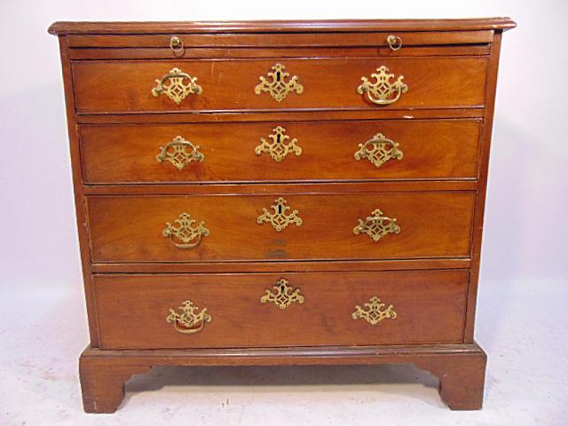 George III bachelors chest, in mahogany, early 19th: George III bachelors chest, in mahogany, early 19th Century, 4 drawers with brass hardware & pull out shelf, cabinet is 33.75" by 19.75", height is 32", some damage to top, base is loose, backboard lo
