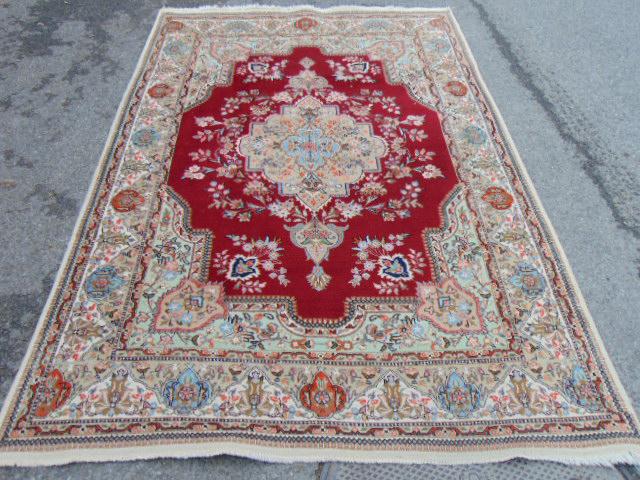 Carpet, in red with center medallion, 8'10" by 5'10": Carpet, in red with center medallion, 8'10" by 5'10"