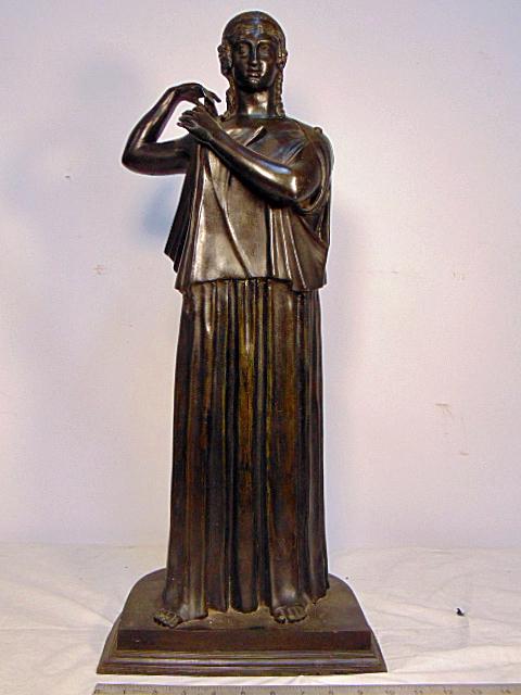 Bronze, Grecian or Roman lady in long robe, clipping on: Bronze, Grecian or Roman lady in long robe, clipping on her mantle, unsigned, dark patina, height is 25"