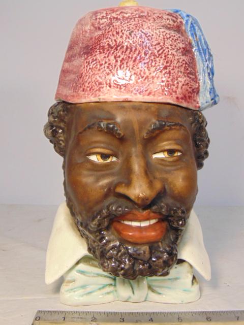 Antique Blackamoor Humidor With Fez, hand painted: Antique Blackamoor Humidor With Fez, hand painted tobacco humidor of a Moorish bust with Fez cap, small hairline on bottom, repair under collar, height is 11.25"