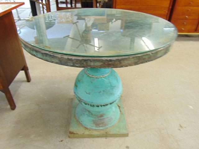 Copper center table with glass top, single pedestal base, green patina, thick glass top, glass has: Copper center table with glass top, single pedestal base, green patina, thick glass top, glass has small chip, top is 36" in diameter, height is 31.25"
