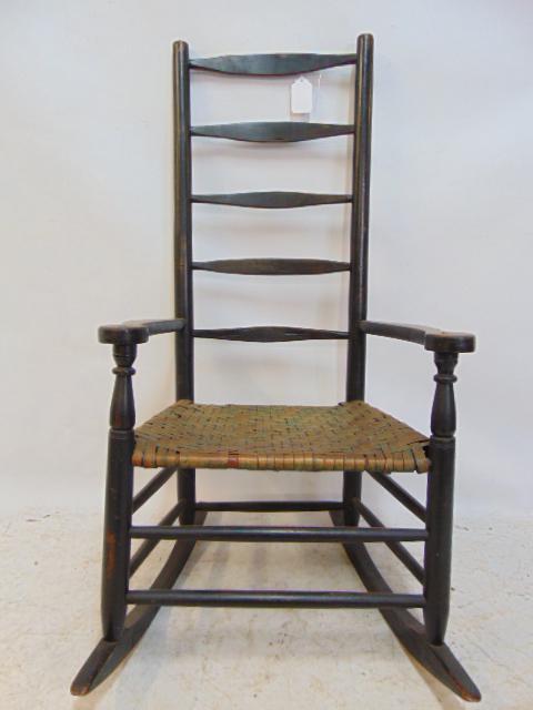 Antique country rocker, ladder-back, black paint, woven seat: Antique country rocker, ladder-back, black paint, woven seat