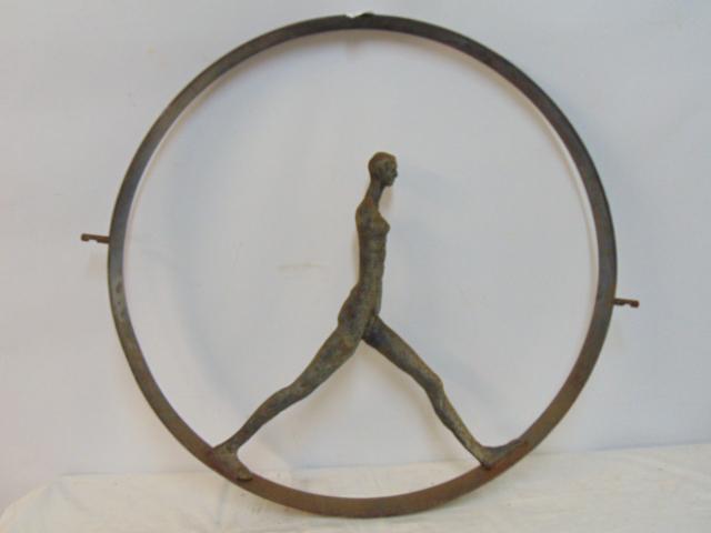 Iron sculpture, walking figure in circle, figures has no arms, diameter is 29.5", unsigned. (1 of 4)