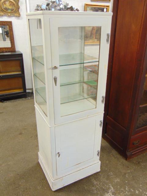 White painted metal medical, dental cabinet with bottom door, top has glass shelves, cabinet is (1 of 4)