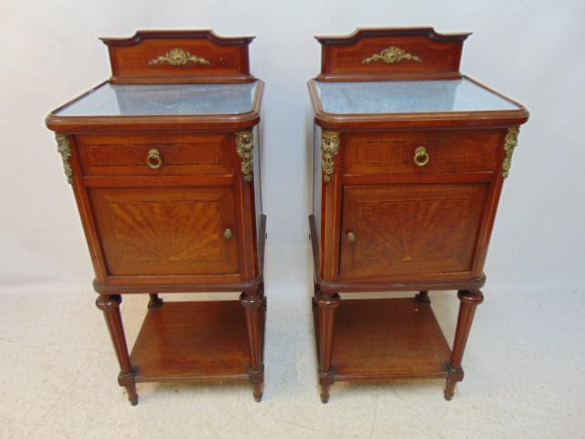 Pair French inlaid nightstands with backsplash, bronze mounted, fine inlay veneers, single drawer: Pair French inlaid nightstands with backsplash, bronze mounted, fine inlay veneers, single drawer over door, stand are 17.25" by 15.25", height is 39, fabric under glass tops, was likely originally ma