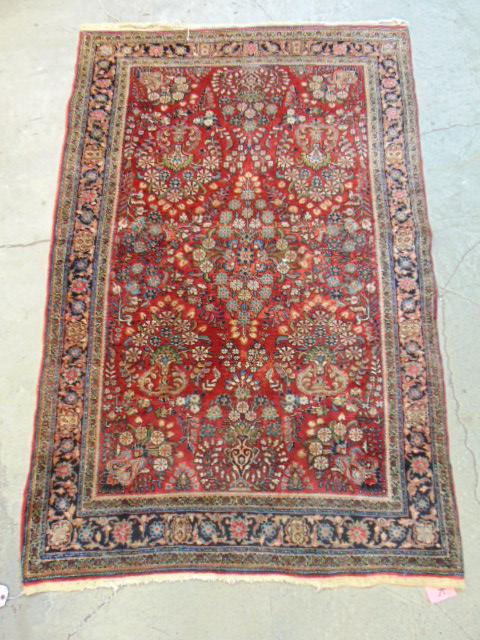 Sarouk carpet, in red, carpet is 6'7" by 4'3", some wear, has small hole, tear in center (1 of 5)