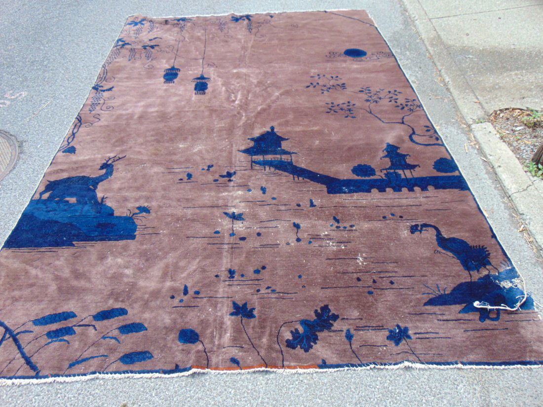 Roomsize Chinese carpet, in brown with scenes in blue, temples, deer, as is, worn, tear in corner (1 of 8)