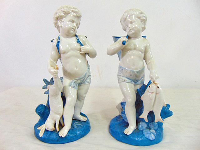 Pair of ceramic cherubs, hunting, fishing theme, signed, in white & blue, one holding a hare, other (1 of 6)