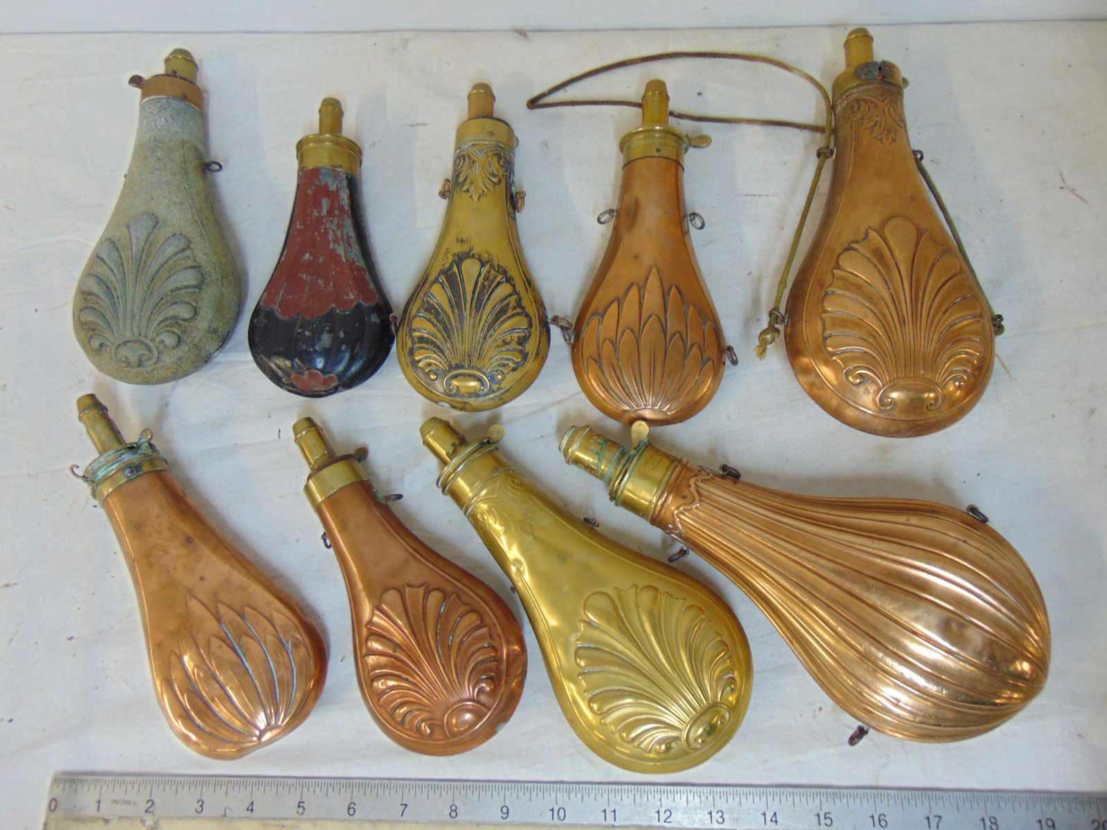 9 antique brass & copper powder flasks, with various decorations, Dixon & Sons Patent, more. (1 of 5)