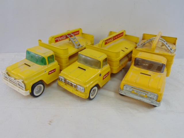 3 Buddy L Coca Cola trucks in yellow, one is complete with two hand trucks, one has missing wheel, (1 of 12)