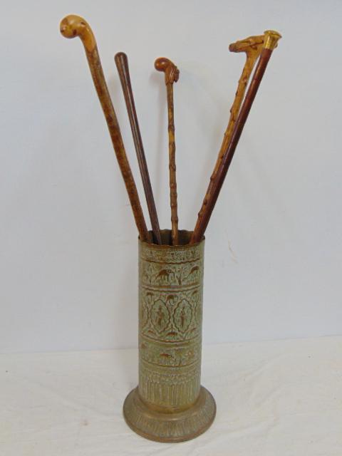 Brass Indian style umbrella stand with canes, includes 5 canes, with gold toned handle, carved head (1 of 5)