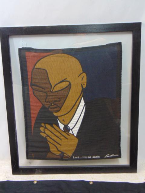 Weaving, Andre Thompson, "Lord, It's Me Again", man praying, 30" by 25.5" (fabric only), framed: Weaving, Andre Thompson, "Lord, It's Me Again", man praying, 30" by 25.5" (fabric only), framed between two sheets of glass.