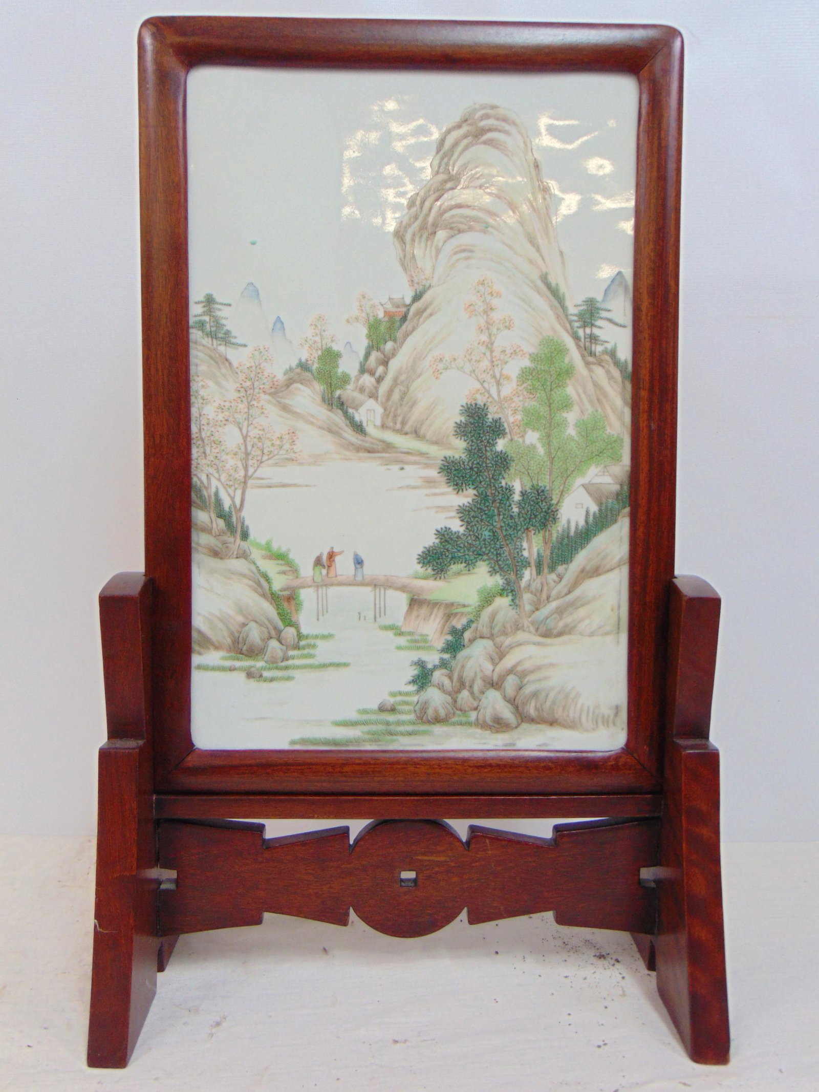 Chinese porcelain plaque, on stand, landscape with mountain & figures on bridge, unsigned, plaque is: Chinese porcelain plaque, on stand, landscape with mountain & figures on bridge, unsigned, plaque is 15" by 10", in good condition, no cracks, chips.
