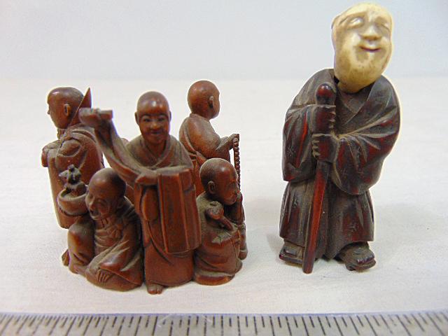 2 boxwood carvings, Japanese Netsuke of a man with carved head & circular carving of various figures: 2 boxwood carvings, Japanese Netsuke of a man with carved head & circular carving of various figures selling wares, (small chip)