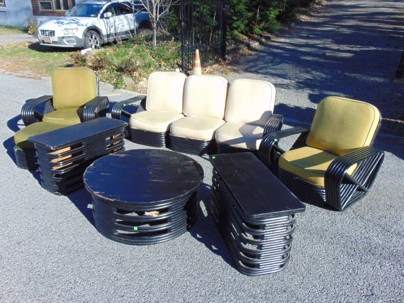Paul Frankl bamboo patio set in black paint, sectional sofa, pair armchairs, pair end tables, round: Paul Frankl bamboo patio set in black paint, sectional sofa, pair armchairs, pair end tables, round coffee table, ottoman, round table has veneer damage, all with original pillows.