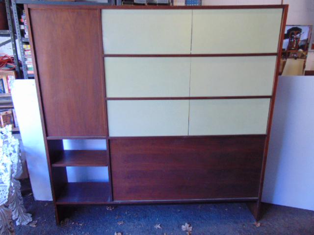 Mid Century shelf, room divider cabinet, shelves on one side, wall with plastic panels on reverse,: Mid Century shelf, room divider cabinet, shelves on one side, wall with plastic panels on reverse, some shelves are adjustable, unit is 68" long, 12" deep, height is 68". missing glass sliding doors