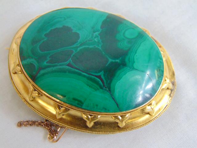 Jewelry. 18kt Antique Malachite brooch. 36.48 grams, a colossal marbled green oval malachite set in: Jewelry. 18kt Antique Malachite brooch. 36.48 grams, a colossal marbled green oval malachite set in a 14kt frame w/ design, Victorian brooch/pin. has bail for pendant. 2 1/2" length 2" width,