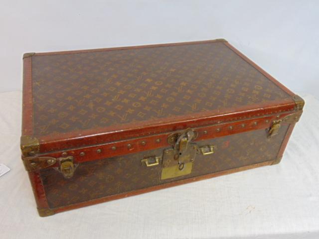 Vintage Louis Vuitton hard case suitcase, with key, few small patch repairs, suitcase is 26" by: Vintage Louis Vuitton hard case suitcase, with key, few small patch repairs, suitcase is 26" by 16.5" by 8.5", handle missing.