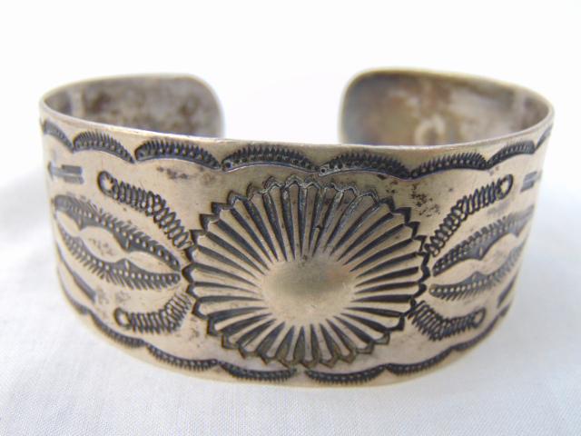 Jewelry. Native American Navajo sterling cuff/bracelet, traditional Navajo stampwork w/ central: Jewelry. Native American Navajo sterling cuff/bracelet, traditional Navajo stampwork w/ central concho design, 3/4" opening gap; 43.29 grams; 1 1/8" wide, 6 3/4" circumference w/o gap. good condition