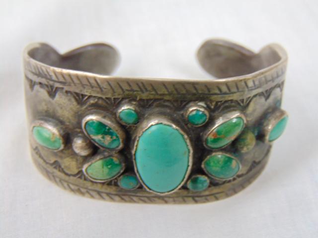 Jewelry. Native American Turquoise multi stone Old Pawn Navajo cuff/bracelet, central blue oval: Jewelry. Native American Turquoise multi stone Old Pawn Navajo cuff/bracelet, central blue oval turquoise surrounded by 8 greenish turquoise stones flanked by (2) oval blue, 7/8" opening gap; 85 grams
