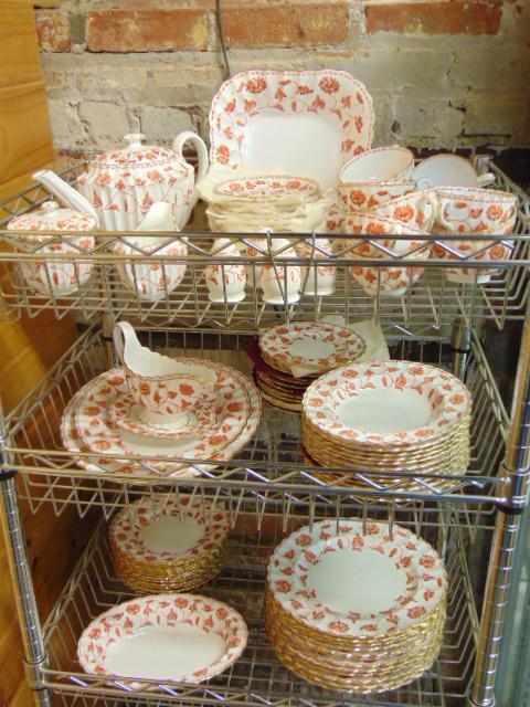 Large set of Spode porcelain dinnerware, with red floral designs & gilt rim, set includes 12 dinner: Large set of Spode porcelain dinnerware, with red floral designs & gilt rim, set includes 12 dinner plates (10 5/8"), 12 soup plates (8"), 12 salad plates (7 7/8"), 12 cake plates (6.25"), 2 serving p